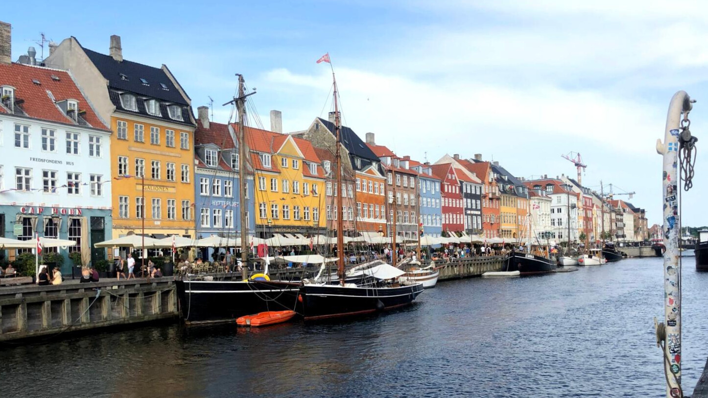 The neighborhood is famous for its colorful houses along the Nyhavn canal, right in the heart of the city center.
